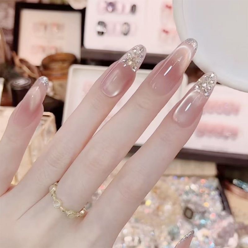 Translucent pink cat-eye gel press-on nails with silver details